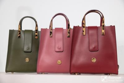 Red, pink, and green handbag at Bisutex