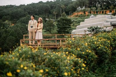 A Japanese tourist couple contemplating a landscape.