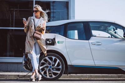 white vehicle with a woman leaning against it