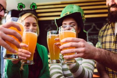 Gente brindando con cerveza en San Patricio