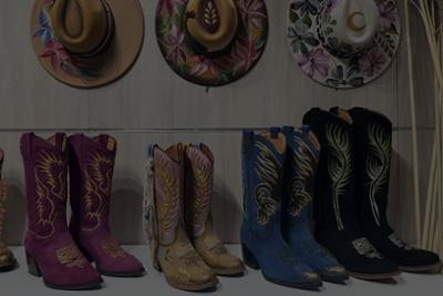 Colourfully embroidered boots and hats at Momad