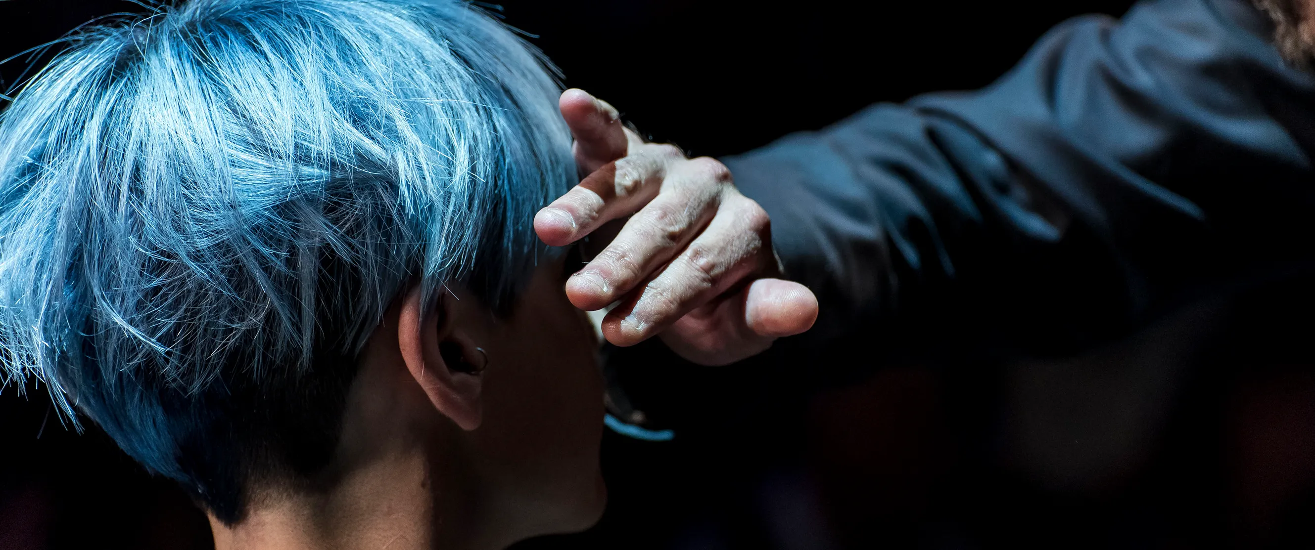 hairdresser putting on the finishing touches