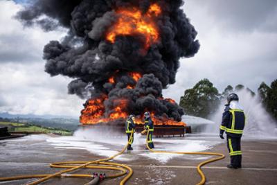 Firefighters fighting an industrial fire