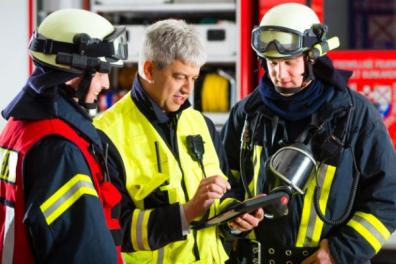 Firefighters and safety team planning emergencies in a company.